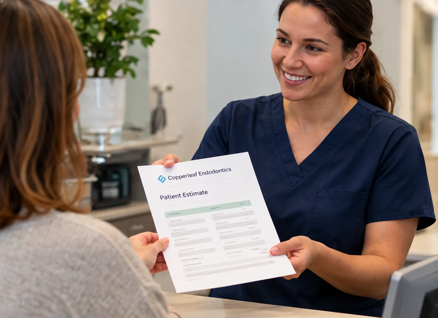 Front-desk team member handing a patient an estimate at checkout